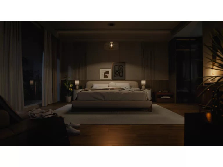Modern bedroom with a bed in the center, dimly lit.