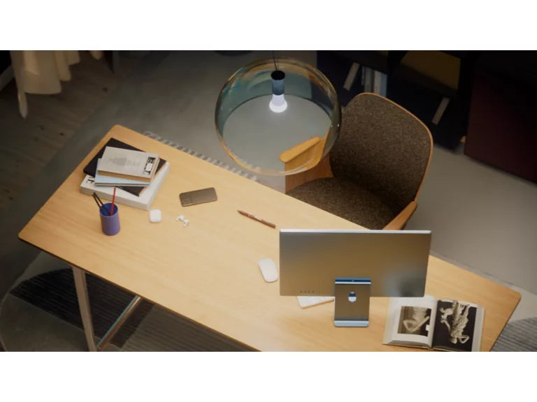 Wooden desk with office supplies and a chair in an office setting with the Philips Hue A60 White Globe