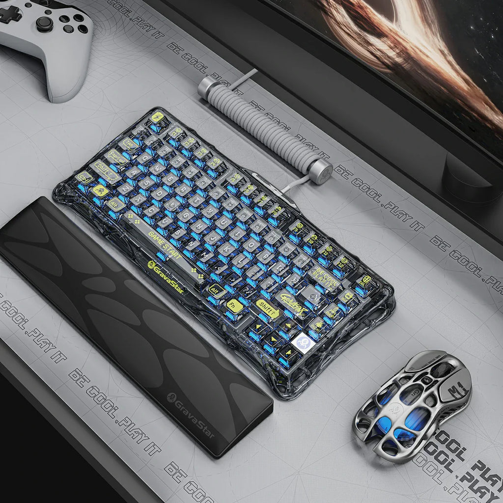 Gravastar Gaming keyboard and mouse on a desk with a computer monitor in the background