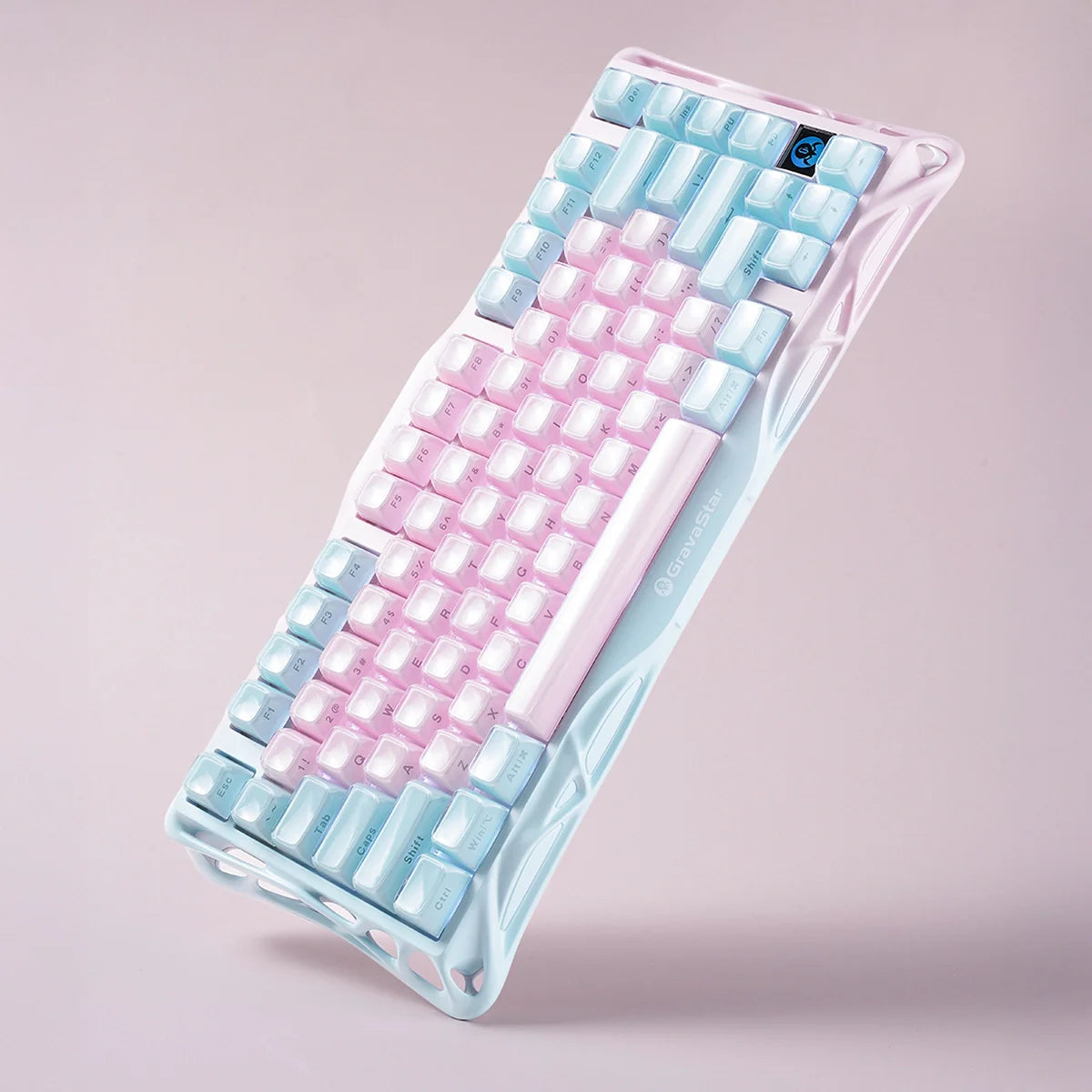 Colorful keyboard with pink and blue keys on a light pink background