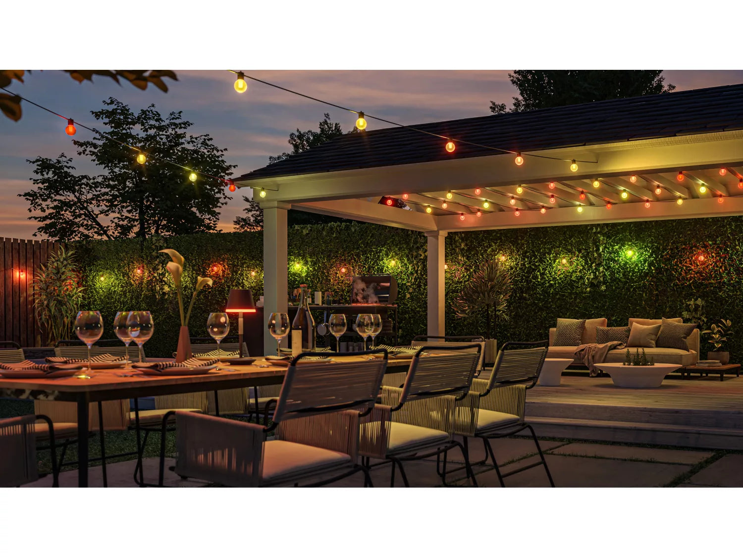 Outdoor patio setting with string lights, tableware, and furniture.