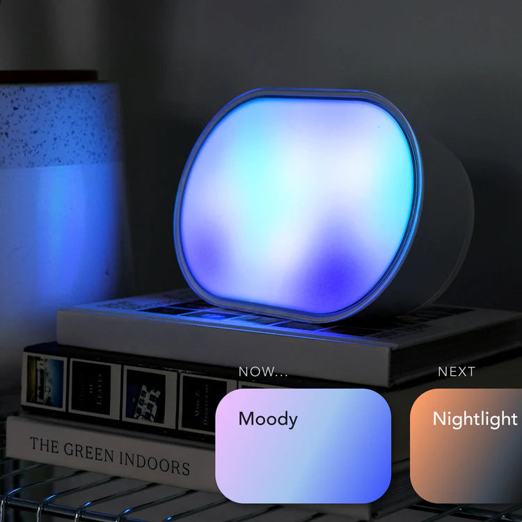 Round night light with color options on a dark background