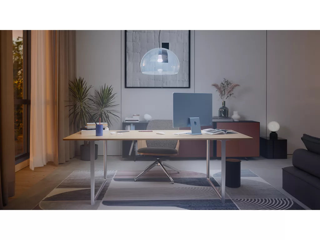 Modern office space with a desk, chairs, and decor elements lit by philips hue white ambiance globe