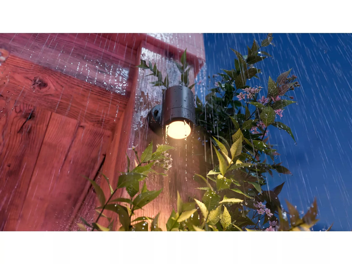 Philips Hue Struana Wall Spotlight on a pillar in the rain