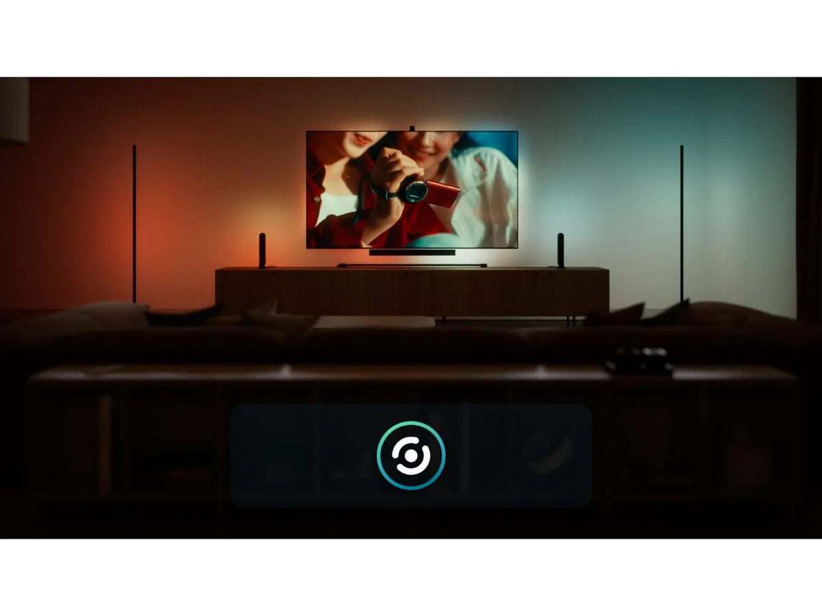 Philips Hue Play Gradient Light Strip syncing with the picture on screen, with warm red light on one side of the TV and cool blue light on the other.