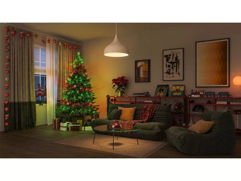Living room decorated for Christmas with a tree, wiz fairy lights, and festive decor.