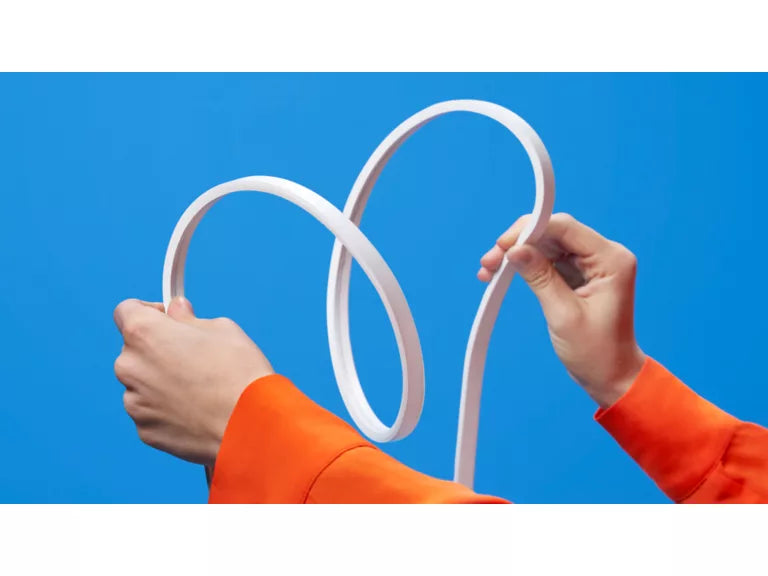 Wiz Smart Flex White held by hands against a blue background