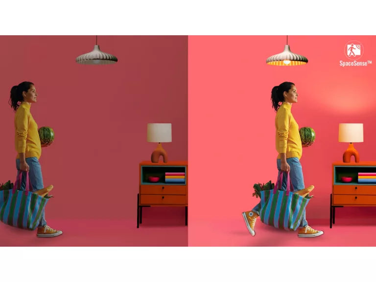 Woman carrying a striped bag with a pink wall and furniture in the background and GU10 smartsense light