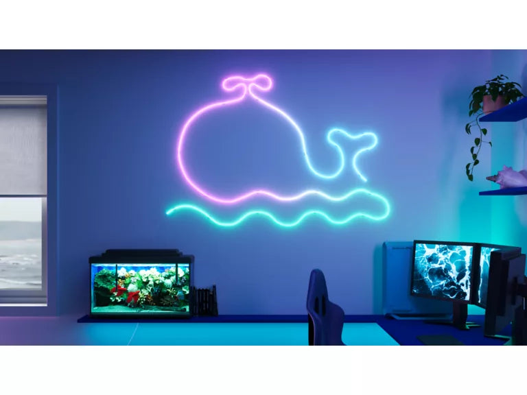Wiz Smart Flex  Neon whale sign on a wall in a room with aquariums and decor.