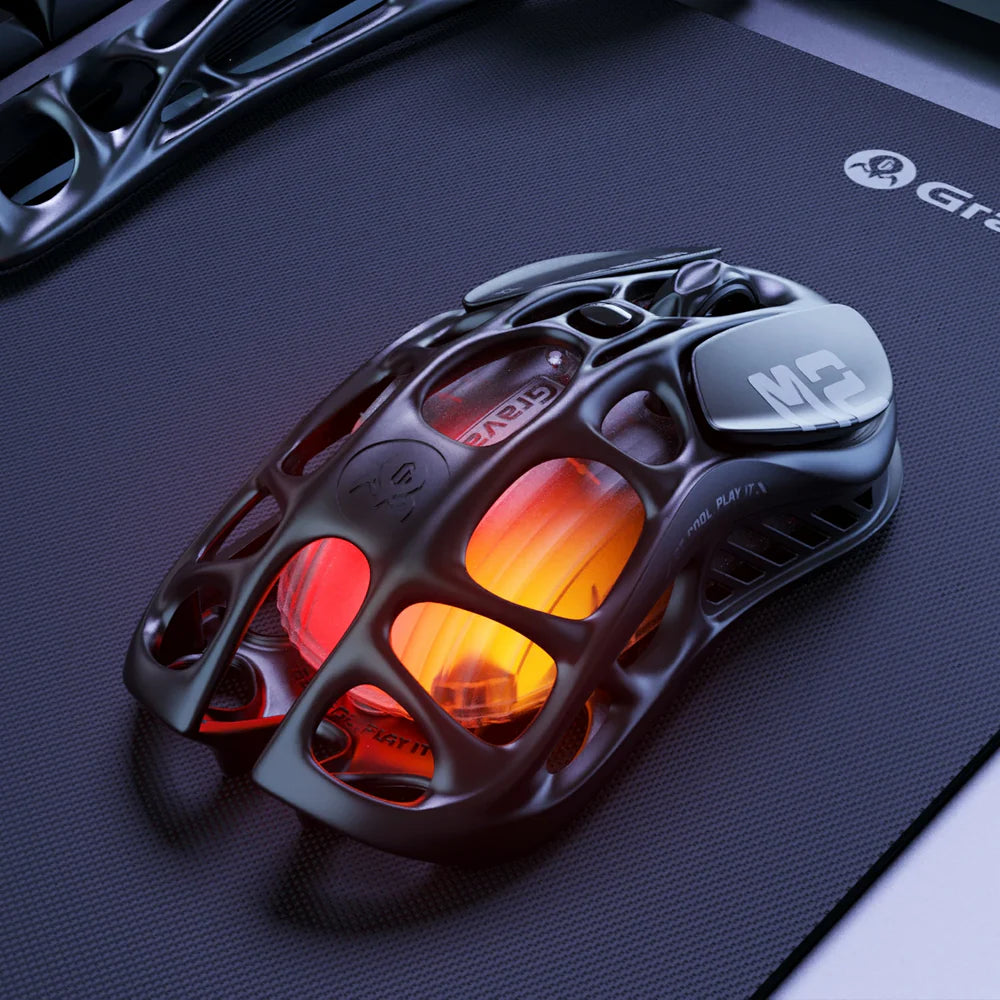 Gaming mouse with glowing red and orange accents on a dark mouse pad with 'Grip' branding.
