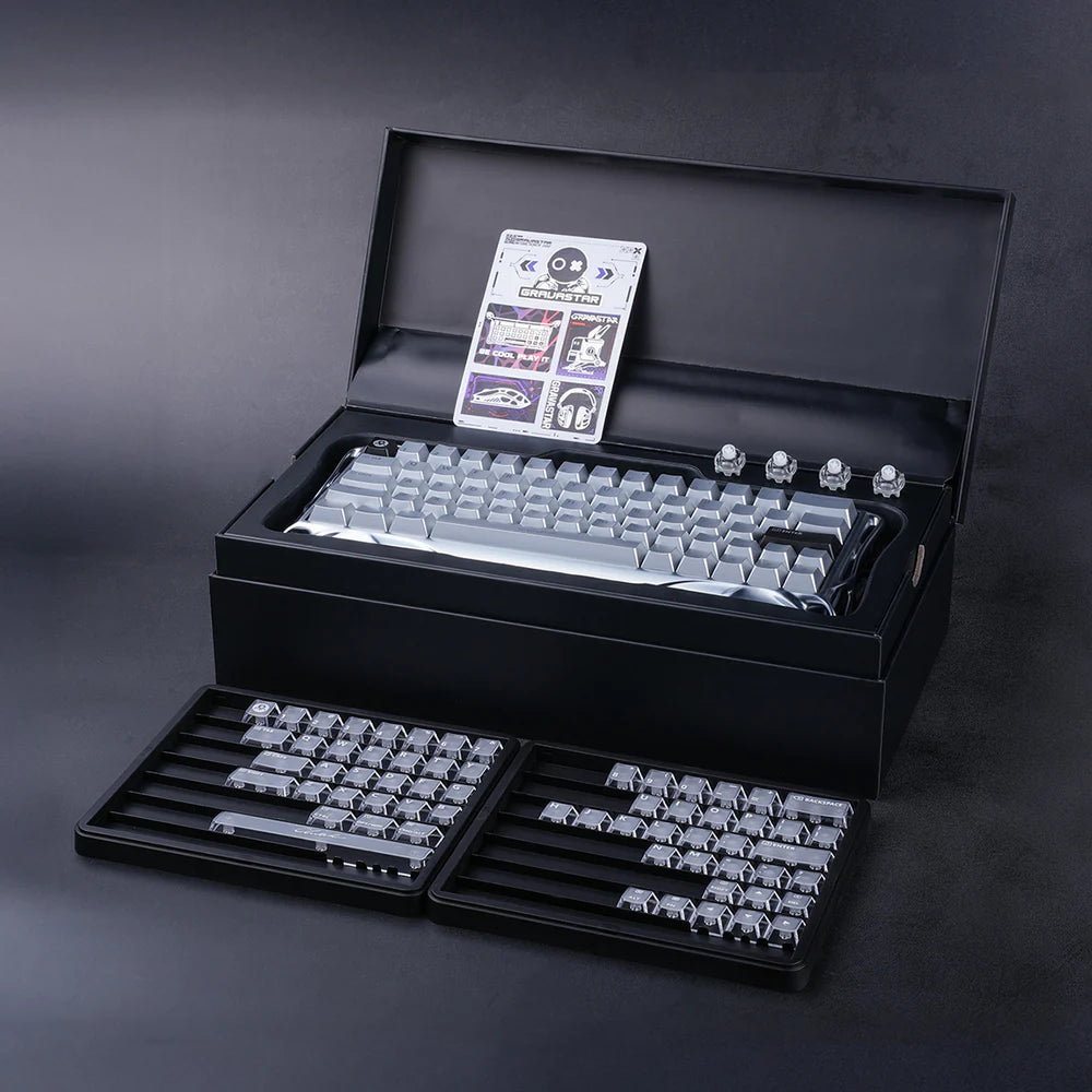Mechanical keyboard components in a black box on a dark background