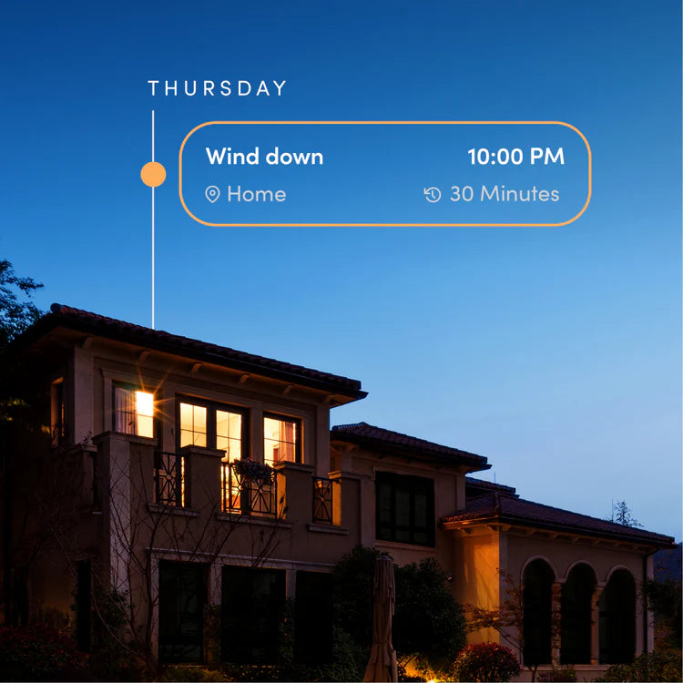 House at night with a digital overlay displaying 'Wind down' and time.