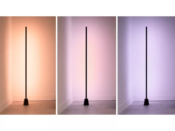 Three views of the wiz gradient floor lamp casting different colored shadows on a white wall.
