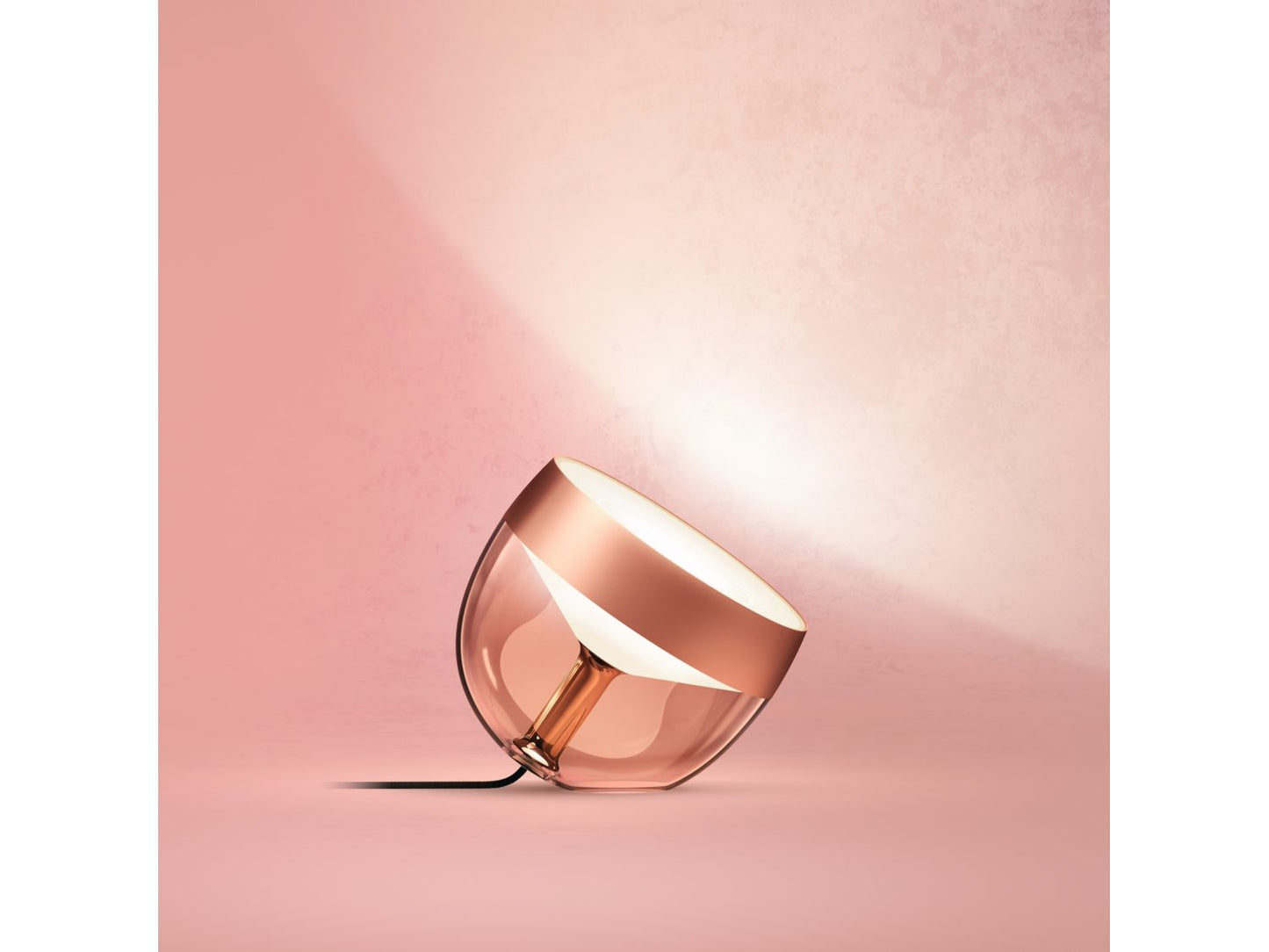 Philips Hue Iris Table Lamp - Copper Special Edition on table
